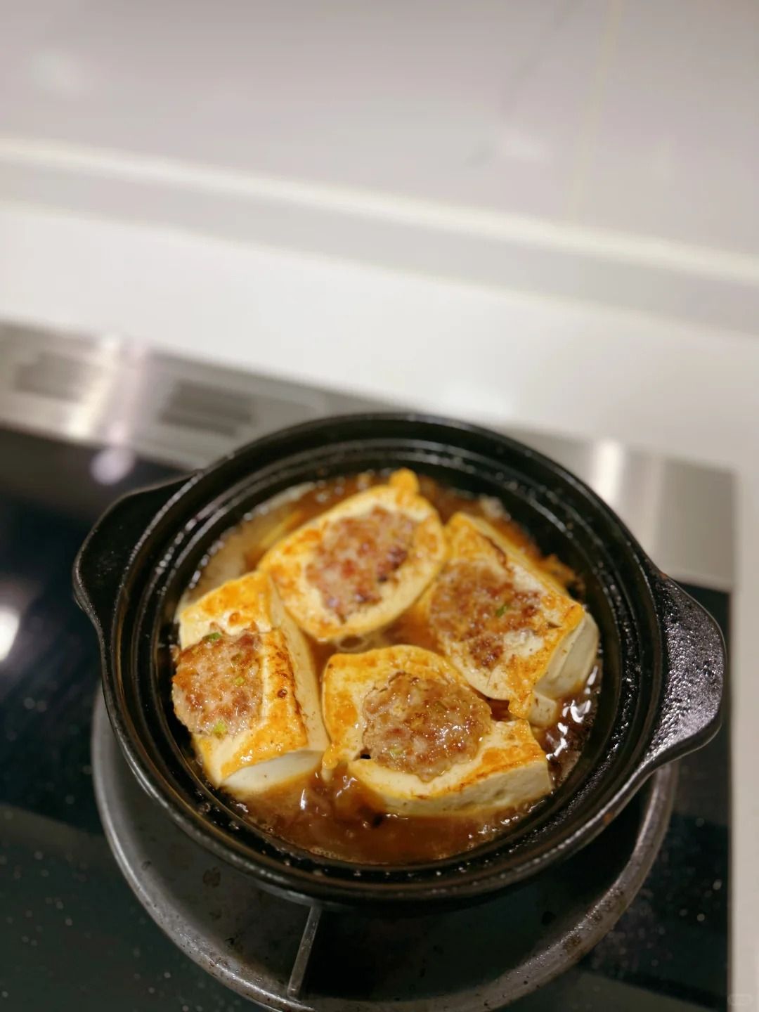 Tofu cooking in clay pot