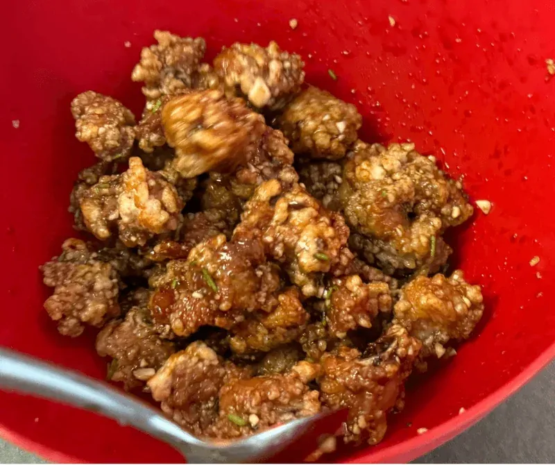 Ribs being tossed in sauce